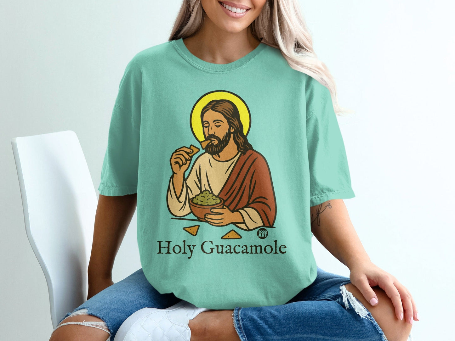 Jesus Christ eating guacamole from a bowl on a t-shirt.