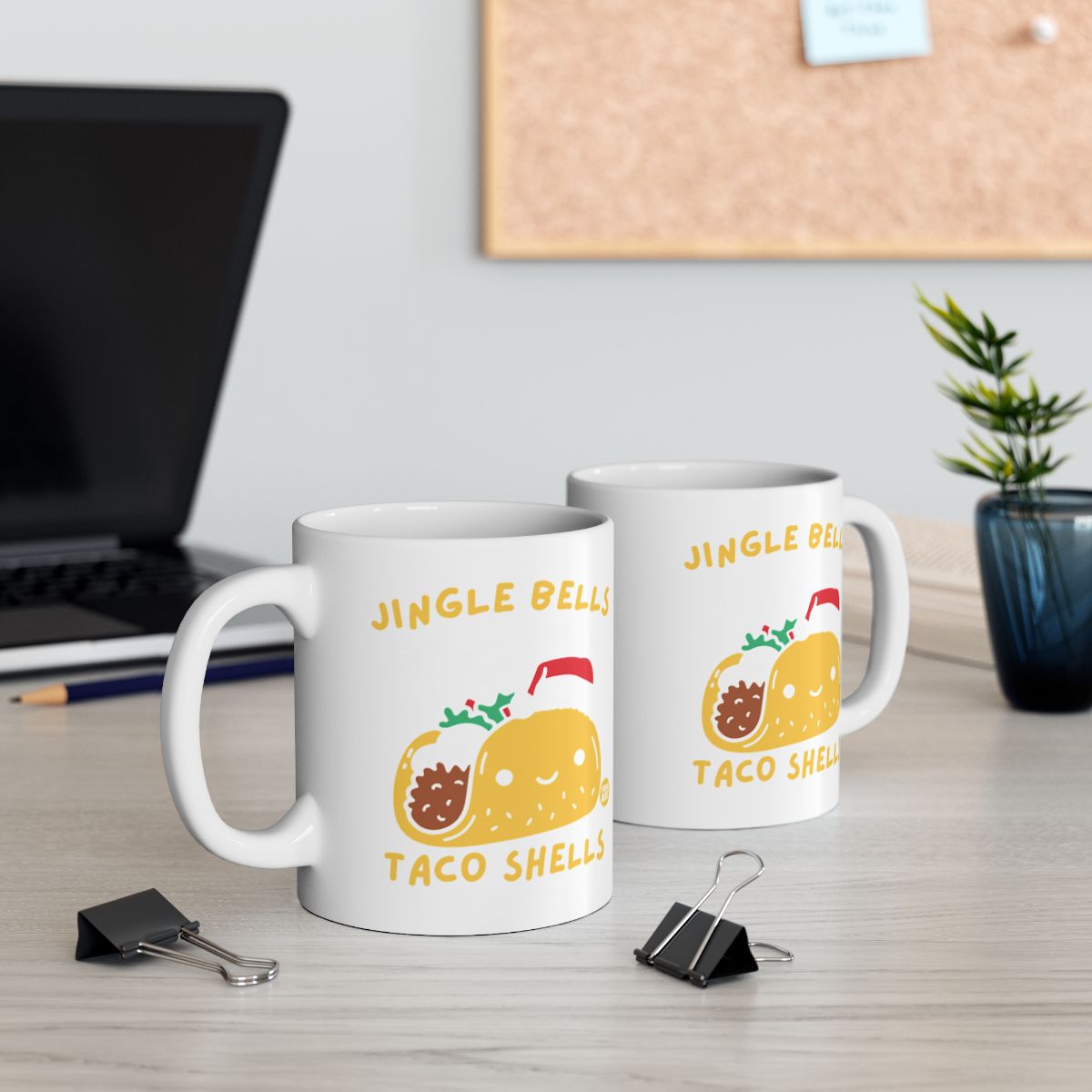 Two white mugs with cartoon tacos and "Jingle Bells Taco Shells" text.
