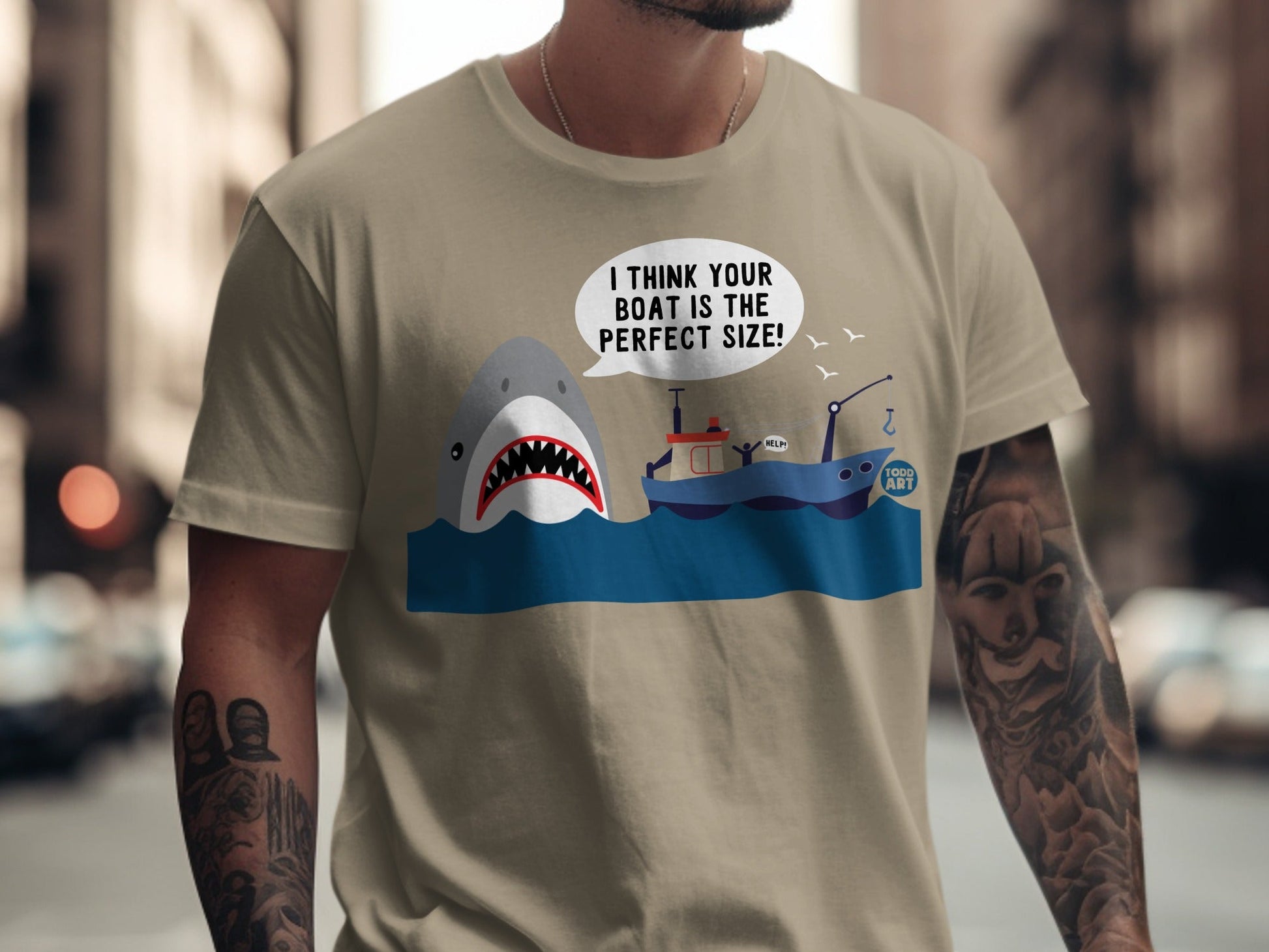 T-shirt with cartoon shark in water, text bubble "I THINK YOUR BOAT IS THE PERFECT SIZE!".