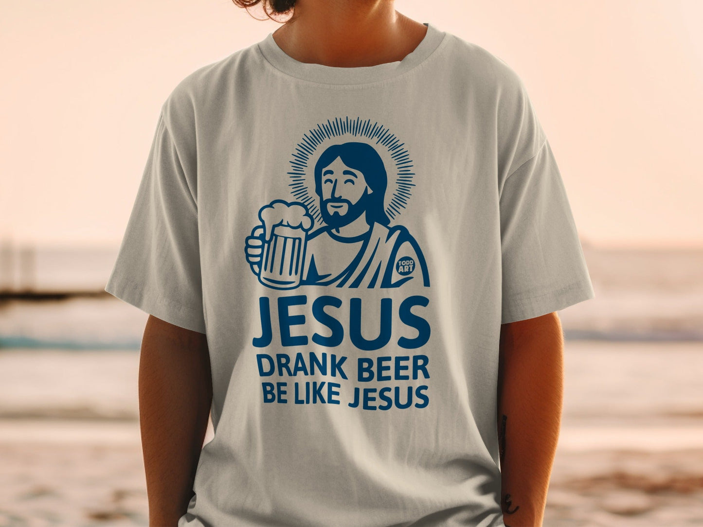 Blue t-shirt with "Jesus Drank Beer Like Jesus" text and illustration.