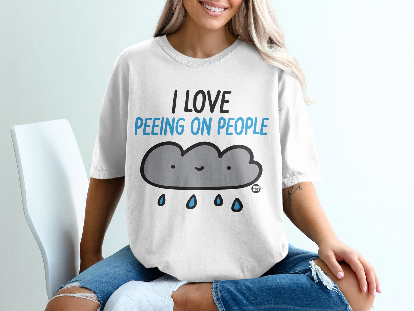 White t-shirt with a cartoon cloud and text "I love peeing on people."