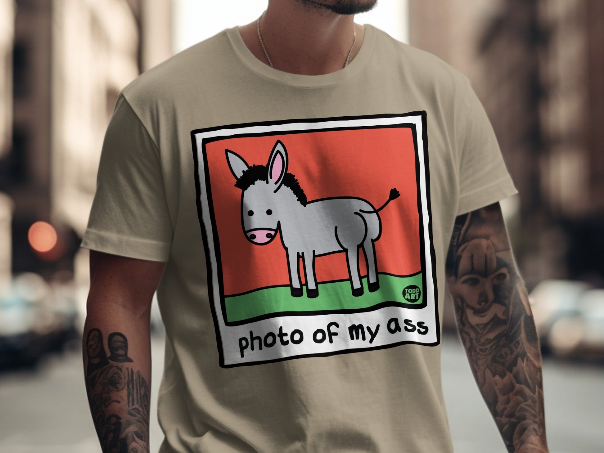 T-shirt featuring cartoon donkey on a red and green background with "photo of my ass" text.