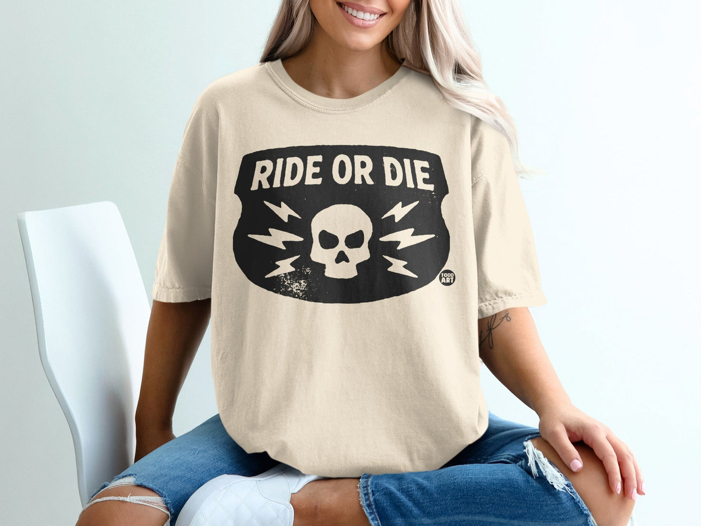 Cream t-shirt with "RIDE OR DIE" and skull graphic.