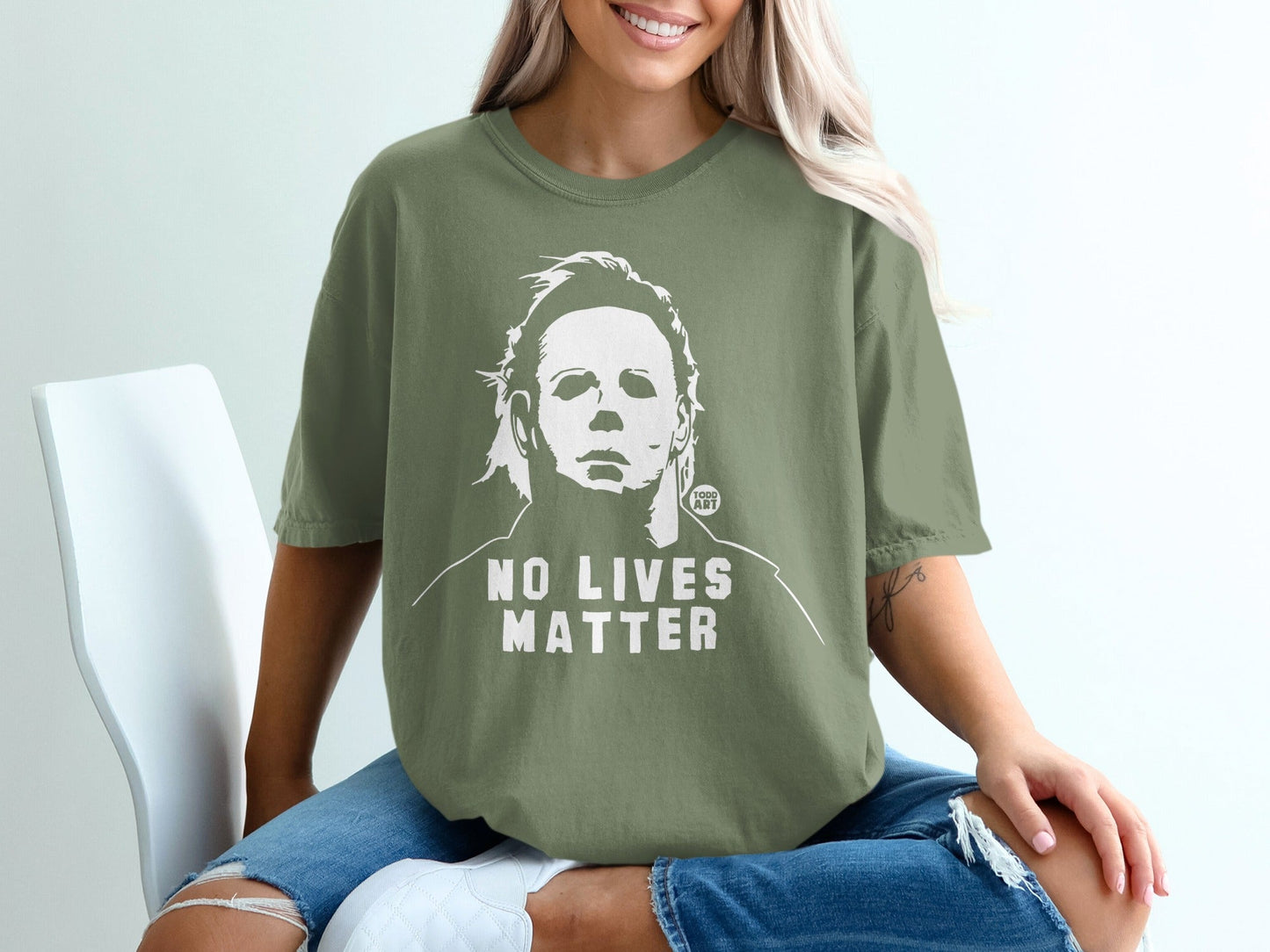 Olive green t-shirt with Michael Myers graphic and "NO LIVES MATTER" text.
