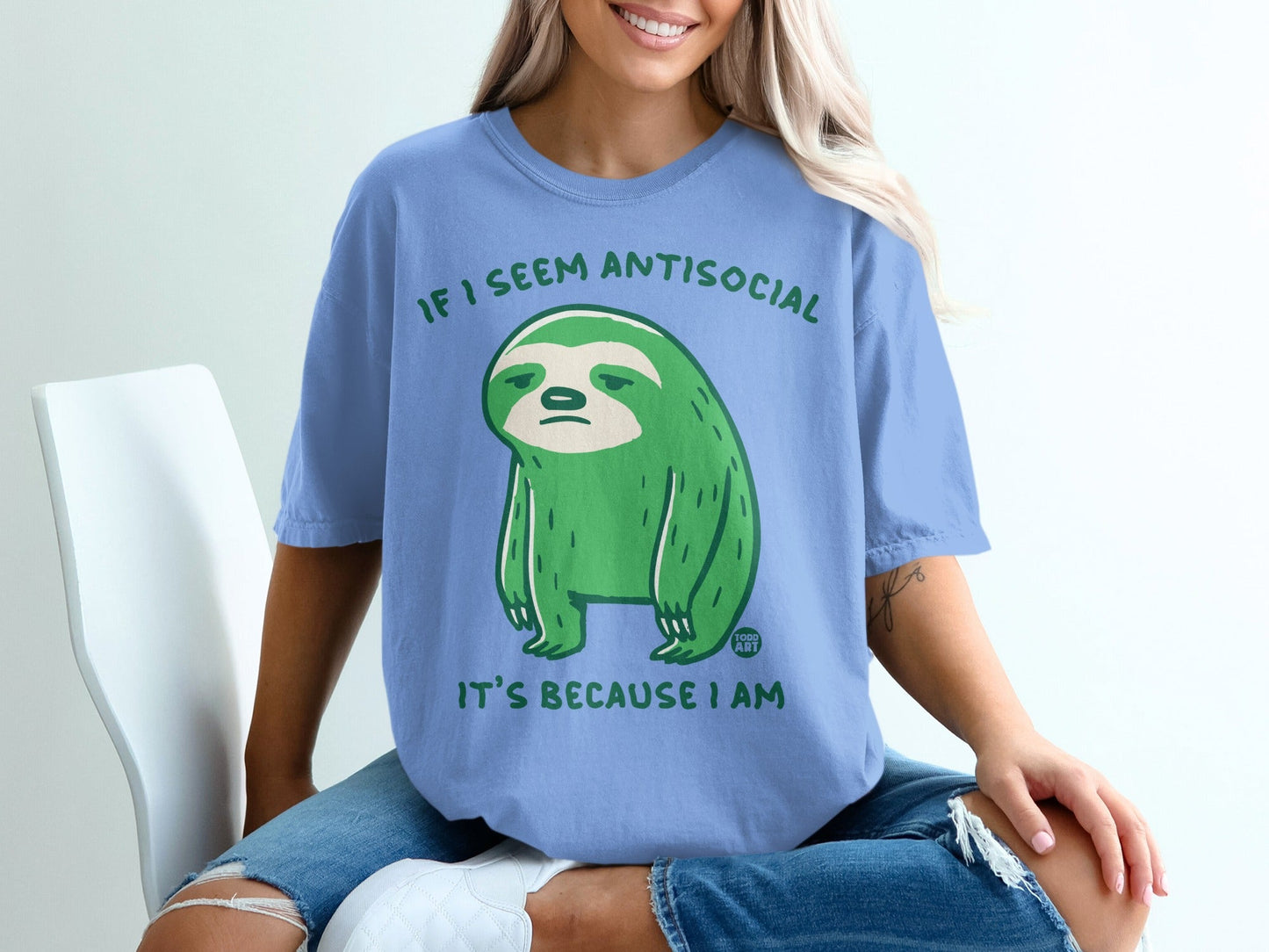 Blue t-shirt with a green sloth illustration and text "IF I SEEM ANTISOCIAL IT'S BECAUSE I AM".