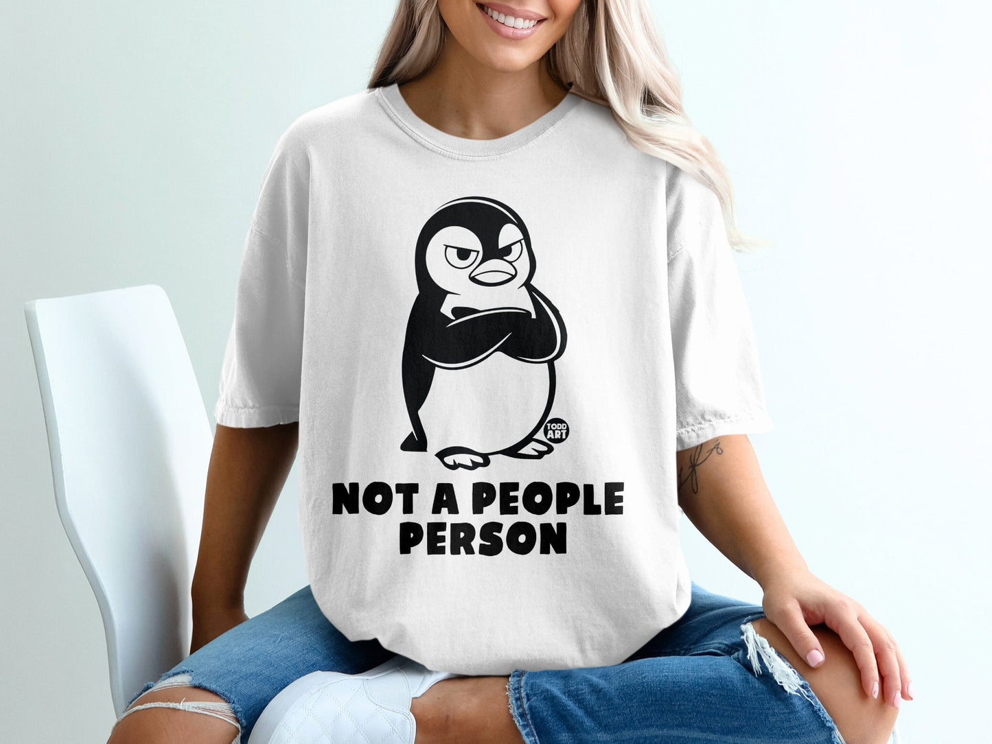 White t-shirt with grumpy penguin and "NOT A PEOPLE PERSON" text.