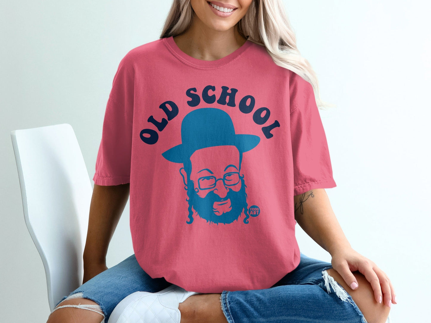 Pink t-shirt with blue "Old School" text and a cartoon man wearing a hat.