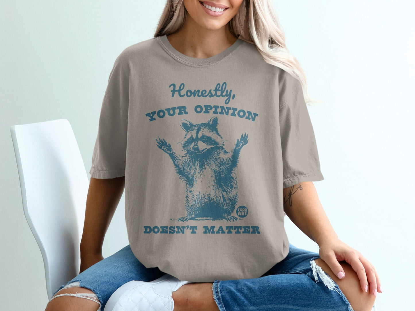 T-shirt with raccoon graphic and text "Honestly, your opinion doesn't matter".