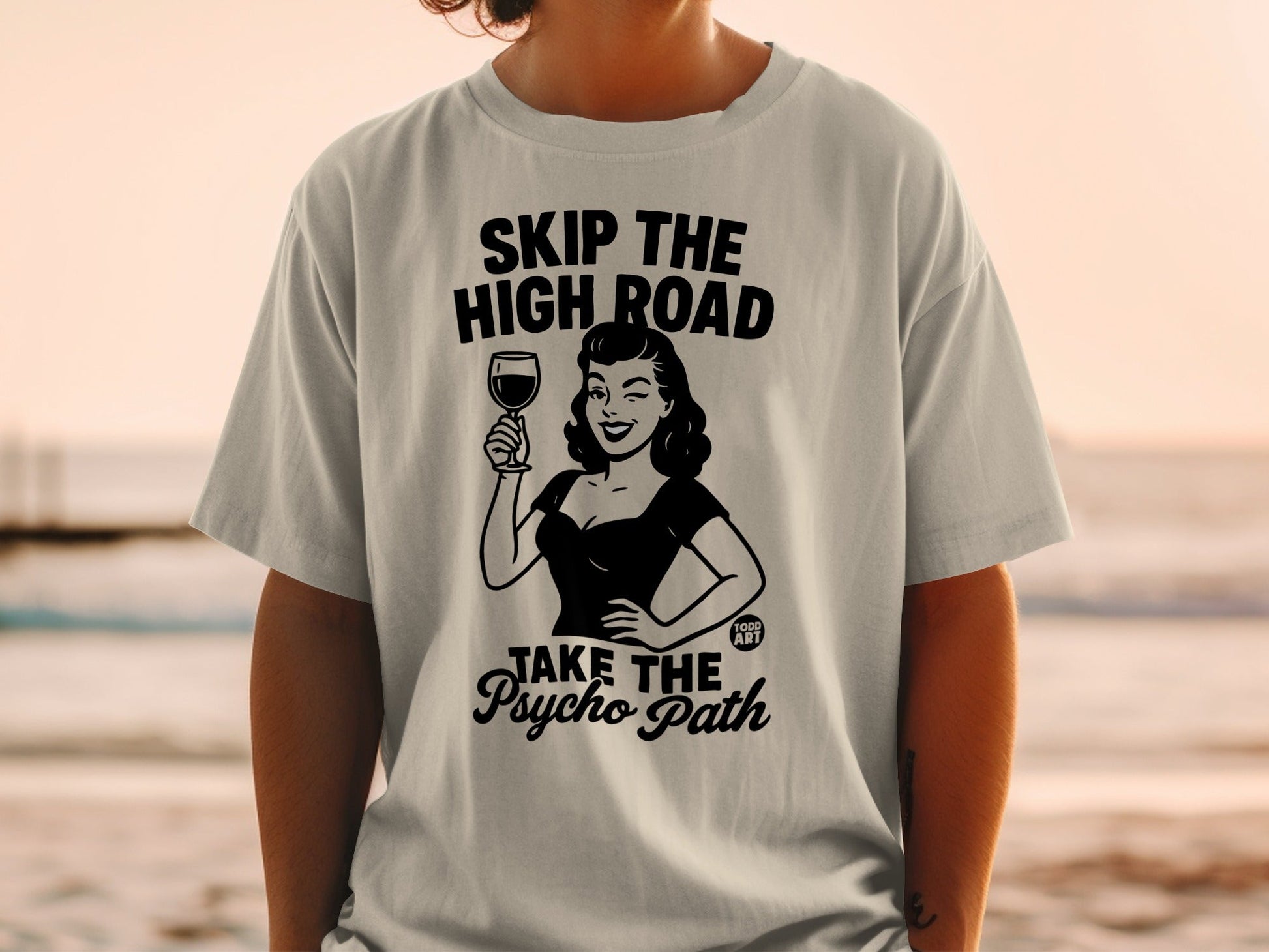 T-shirt with "SKIP THE HIGH ROAD TAKE THE PSYCHO PATH" and retro woman with wine.