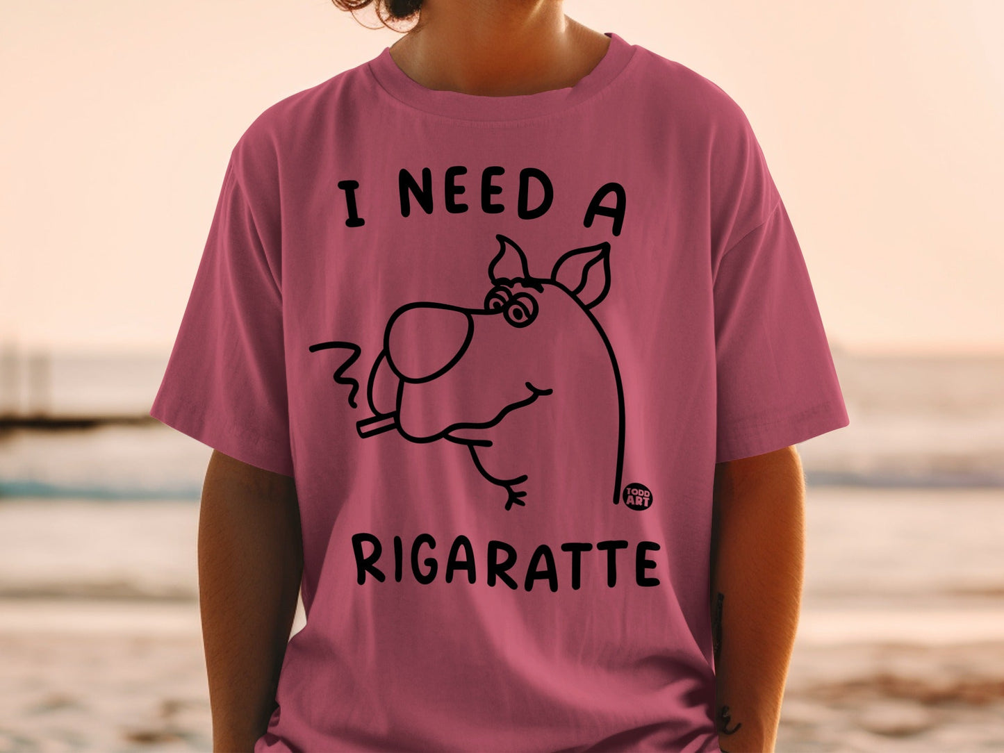 Pink t-shirt with Scooby-Doo cartoon smoking and text "I NEED A RIGARETTE".