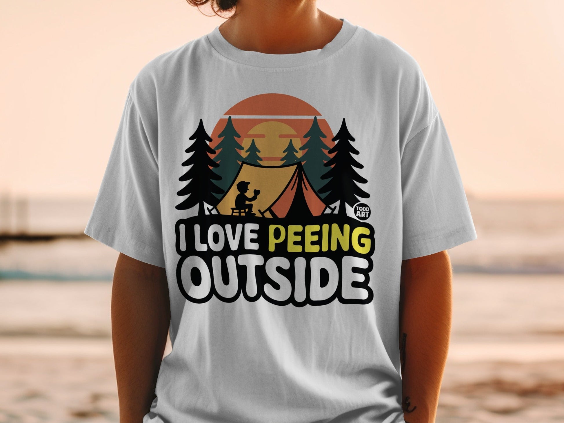 White t-shirt with text "I Love Peeing Outside" and a camping scene.