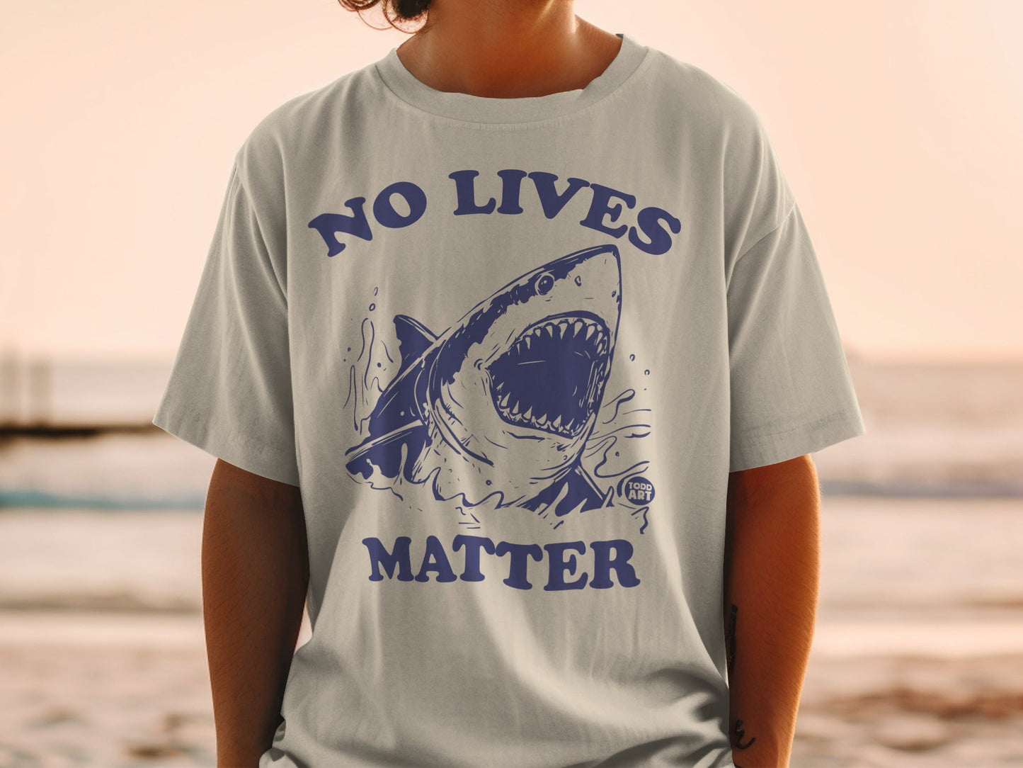 Blue graphic t-shirt with a shark and "NO LIVES MATTER" text.