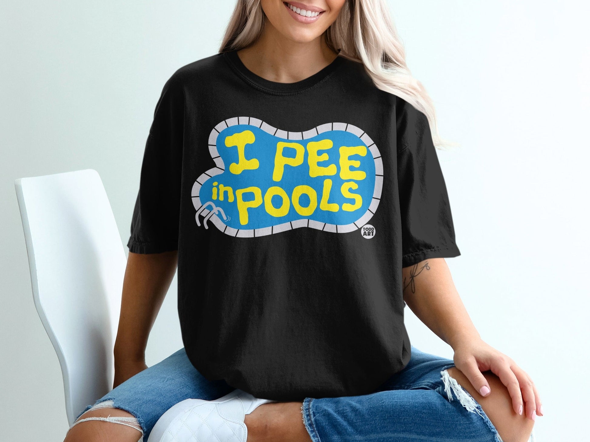 Black t-shirt with "I pee in pools" text in yellow pool shape.