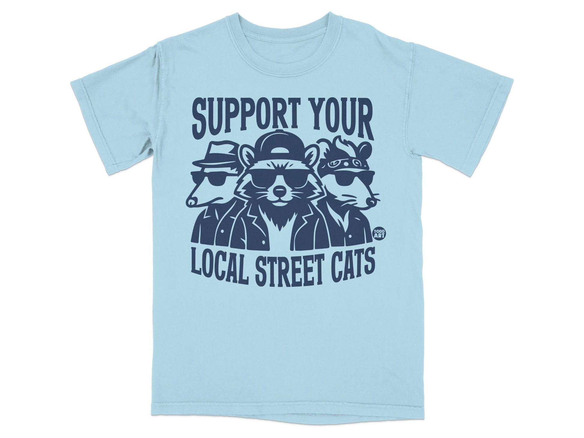 Light blue t-shirt with graphic of three cartoon raccoons wearing hats and sunglasses.