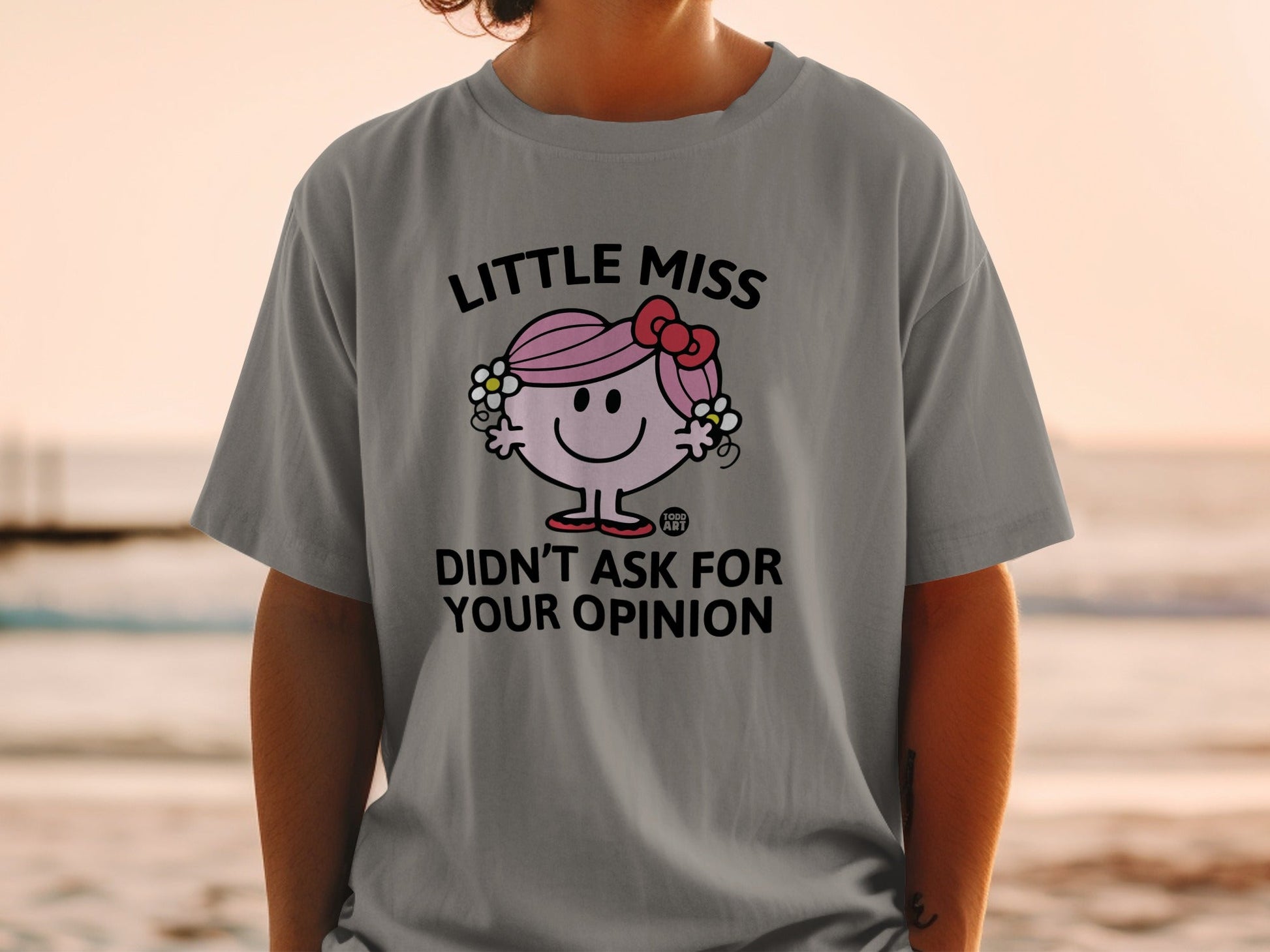 Little Miss character with "Didn't Ask For Your Opinion" text on a grey t-shirt.