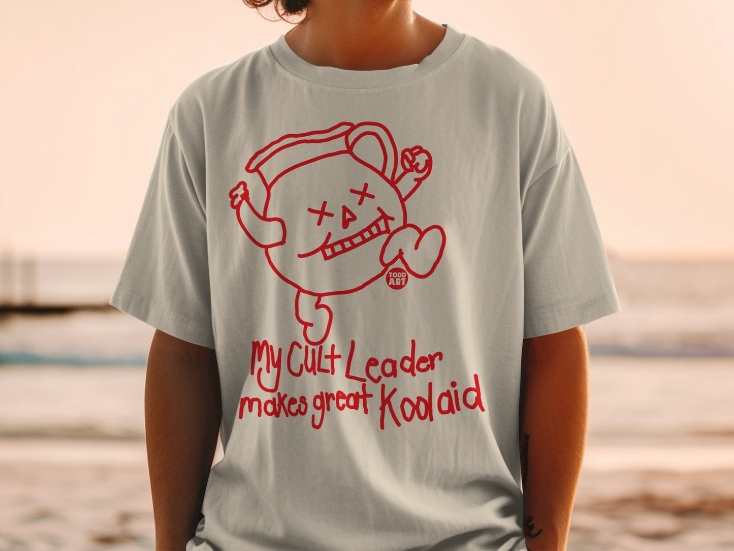 T-shirt with cartoon Kool-Aid pitcher and "My Cult Leader makes great Kool-Aid" text.