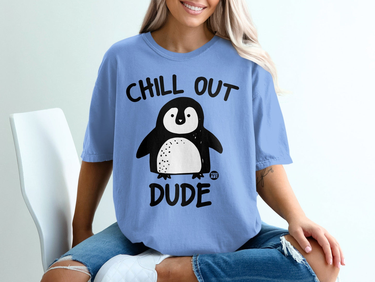Blue t-shirt with cartoon penguin and text "CHILL OUT DUDE".