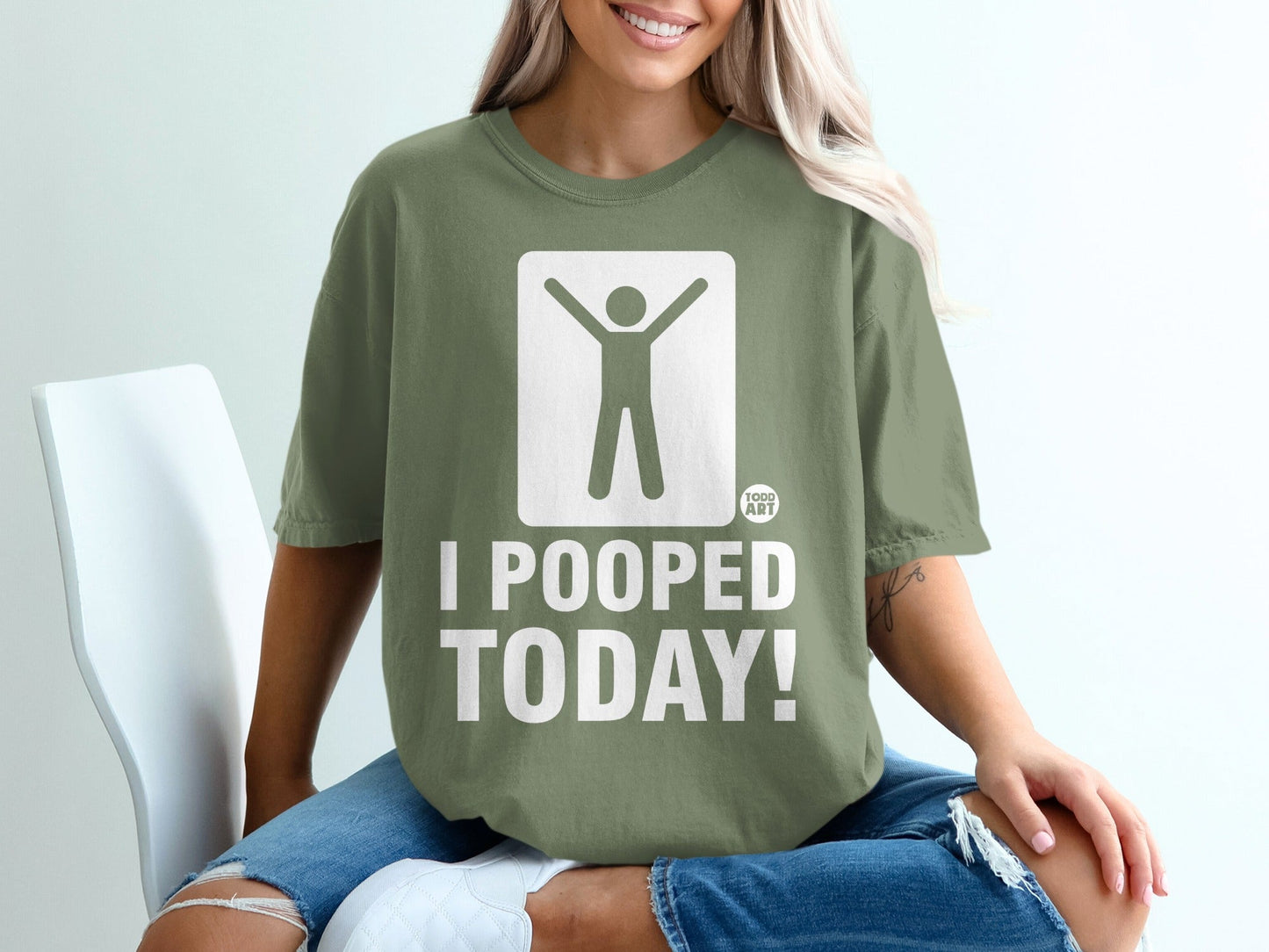 Green t-shirt with white graphic of person with arms raised and text "I POOPED TODAY!".