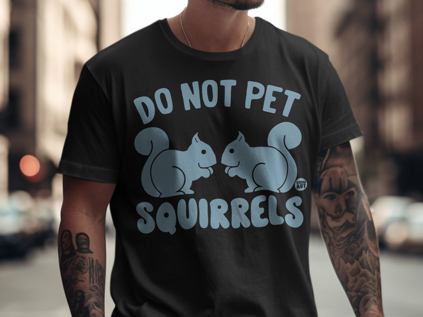 Black t-shirt with cartoon squirrels and "DO NOT PET SQUIRRELS" text.