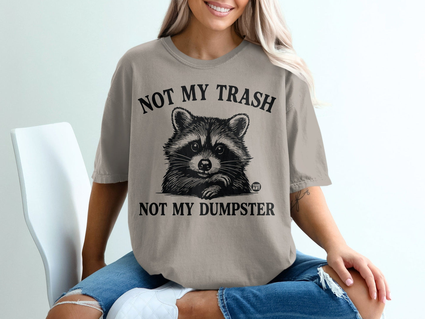 T-shirt with raccoon graphic and "Not My Trash, Not My Dumpster" text.