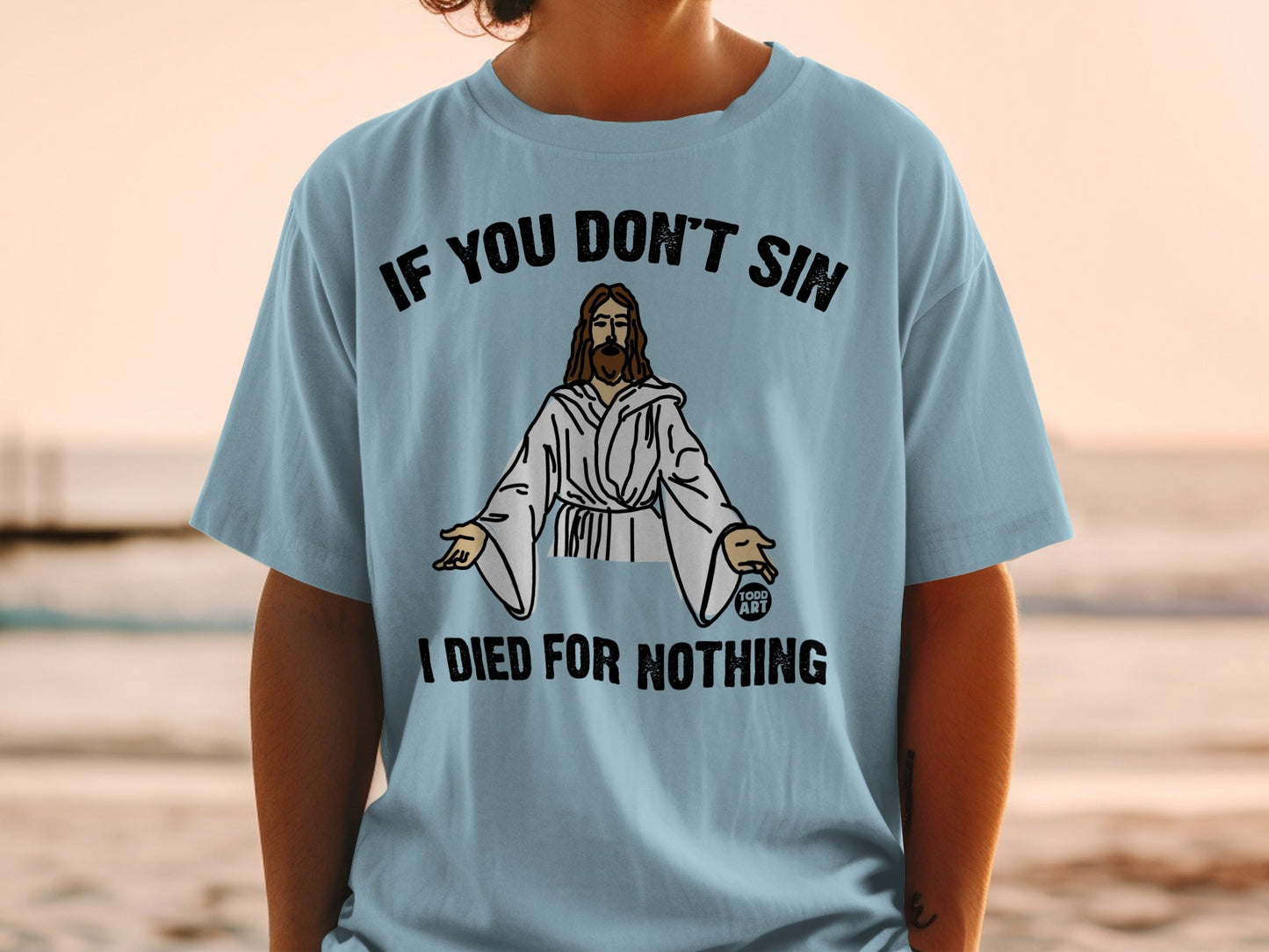 Light blue t-shirt with "If You Don't Sin I Died For Nothing" and Jesus graphic.