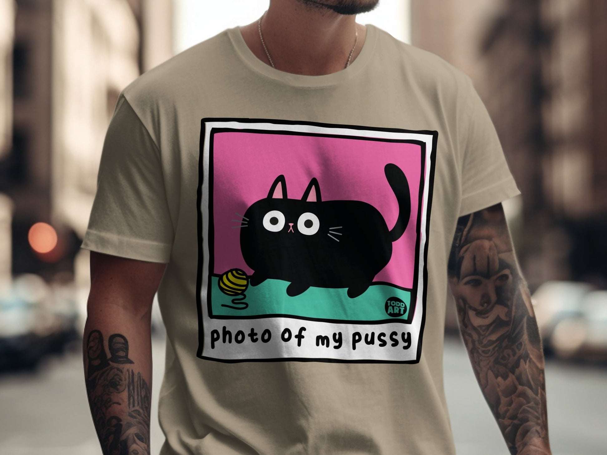 Black cat with yarn ball on tan t-shirt with "Photo of my Pussy" text.