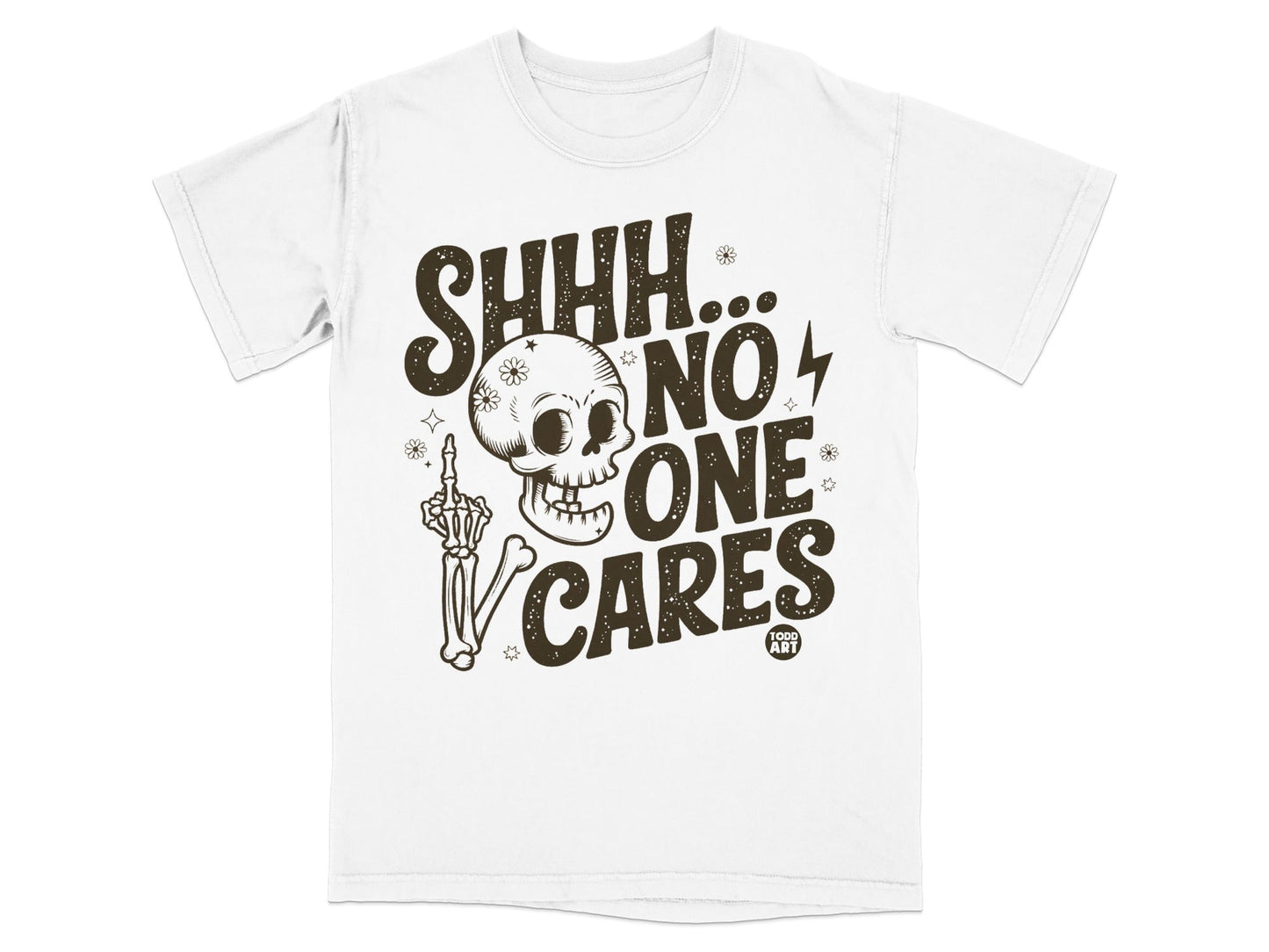 White t-shirt with brown graphic of skull, skeleton hand, and text "SHHH... NO ONE CARES"