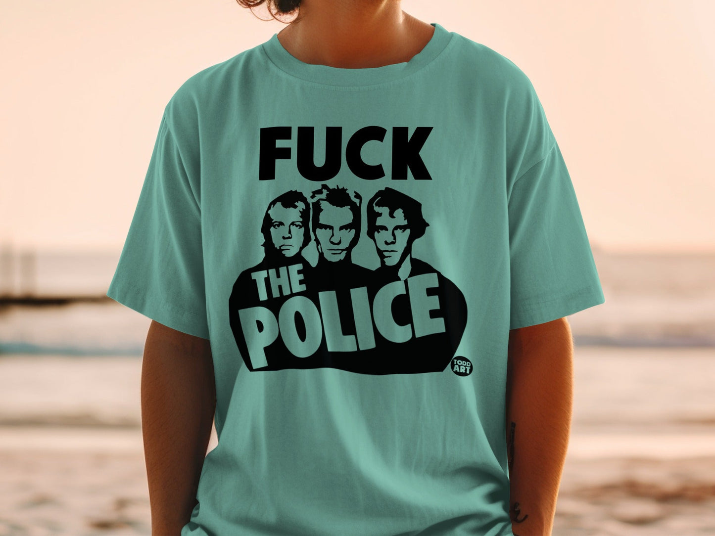 Teal t-shirt with "FUCK THE POLICE" text and three men's faces.