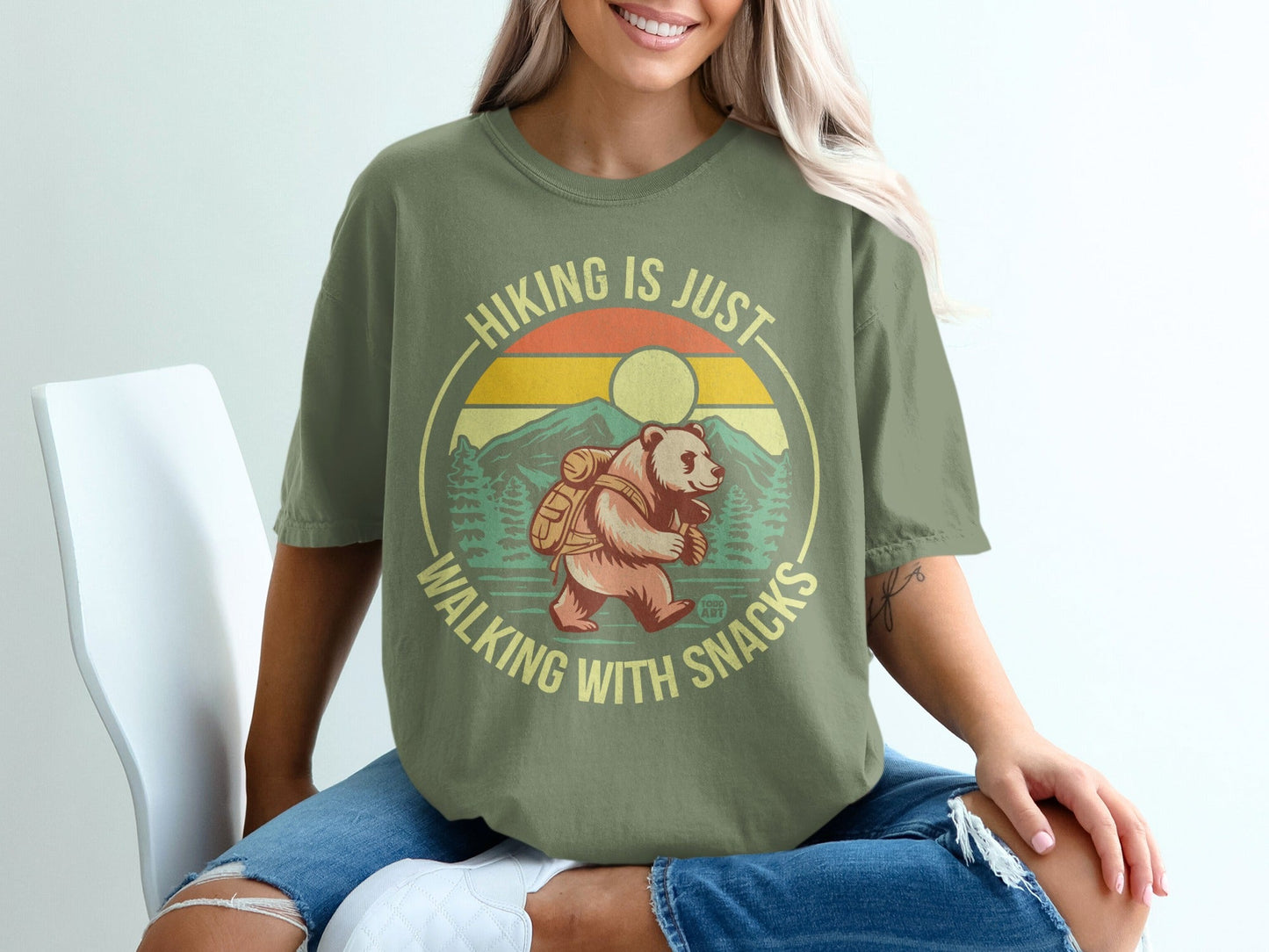 Olive t-shirt with bear hiking graphic and text "Hiking is just walking with snacks."