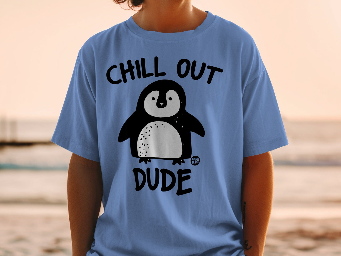 Blue t-shirt with cartoon penguin and "CHILL OUT DUDE" text.