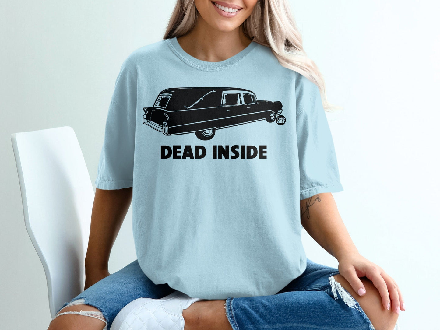 Light blue t-shirt with black hearse graphic and "DEAD INSIDE" text.