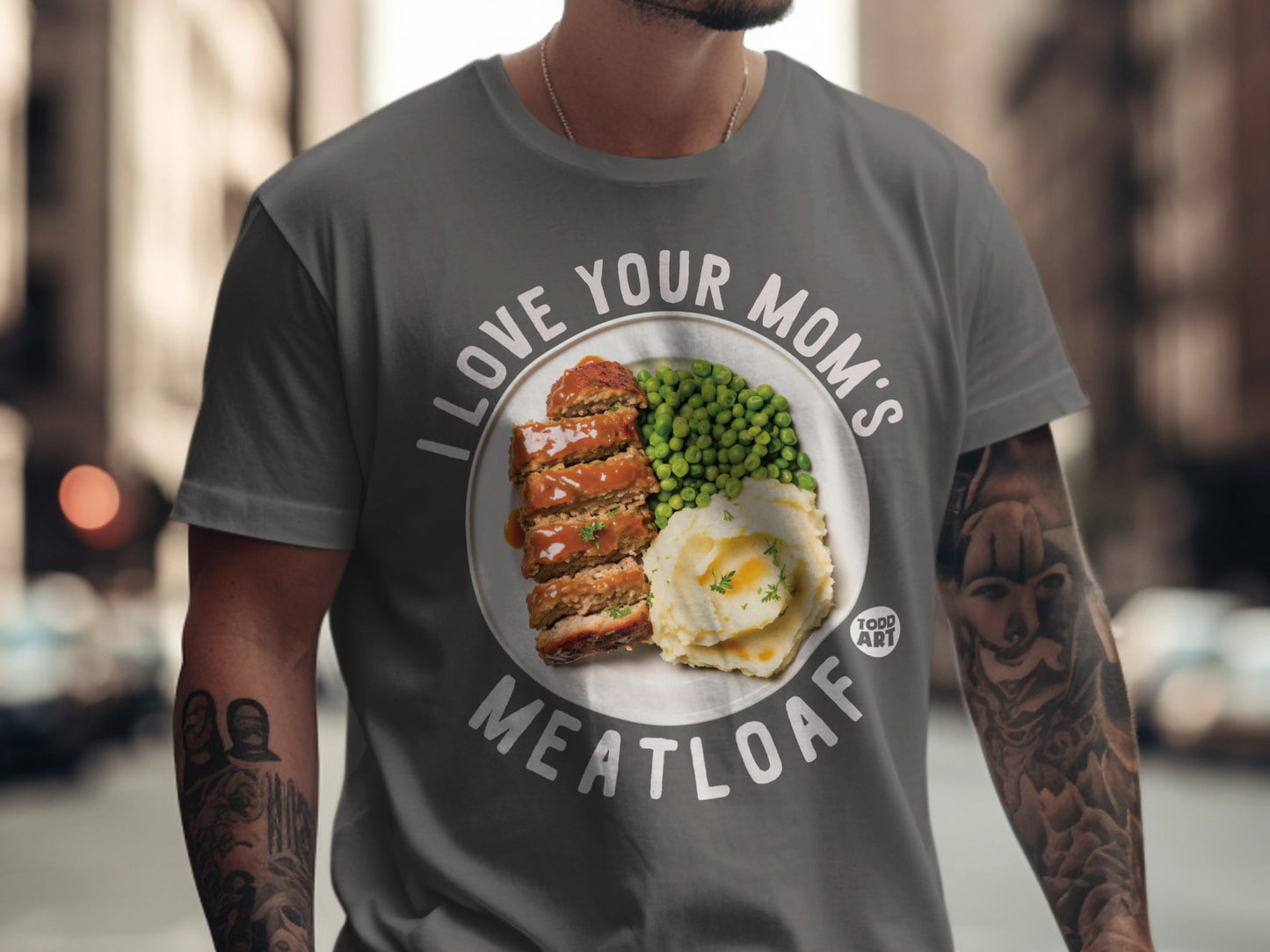 T-shirt with "I love your mom's meatloaf" text and image of meatloaf, mashed potatoes, and peas.