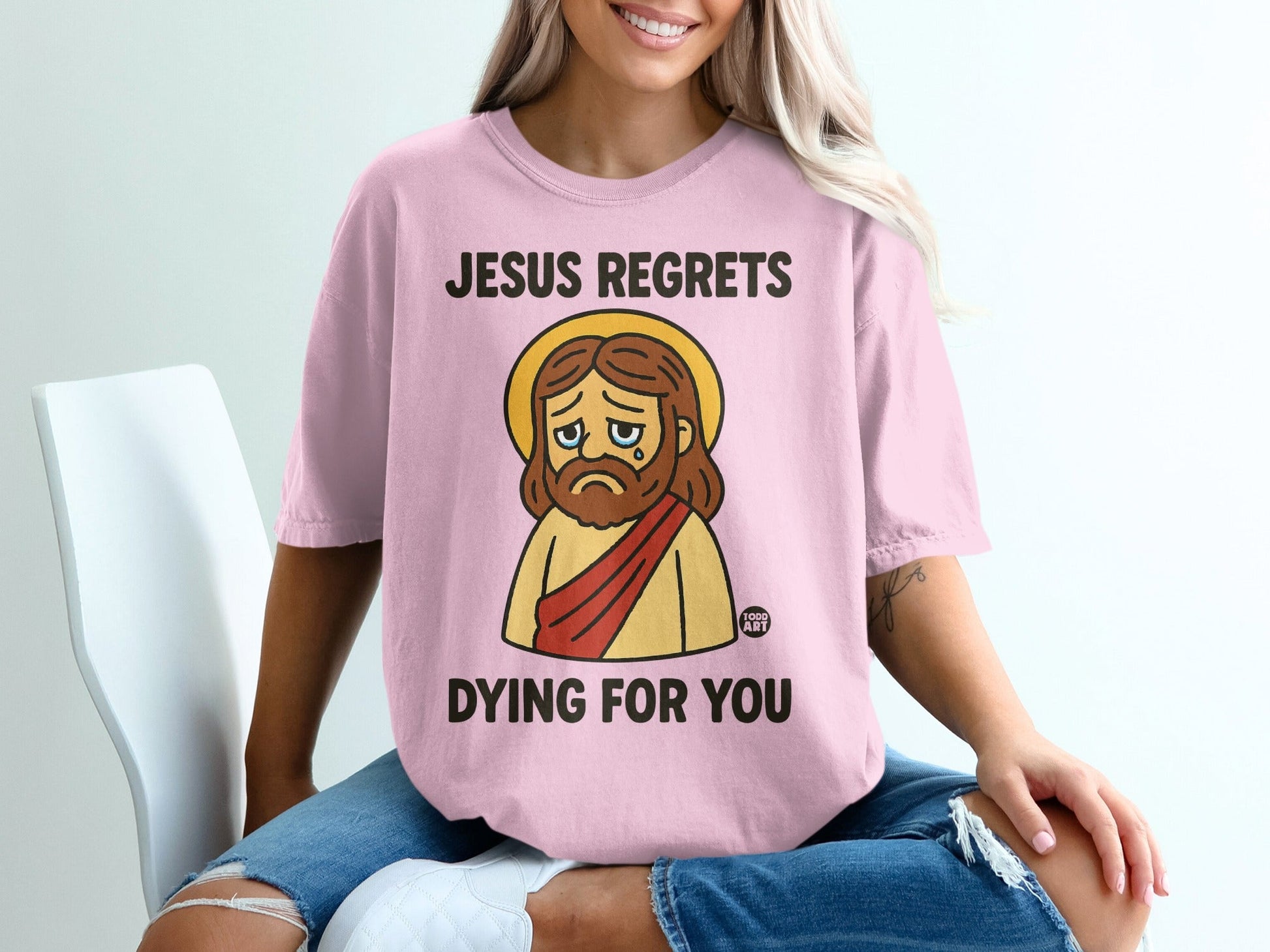 Jesus regrets dying for you graphic tee with a sad Jesus illustration.