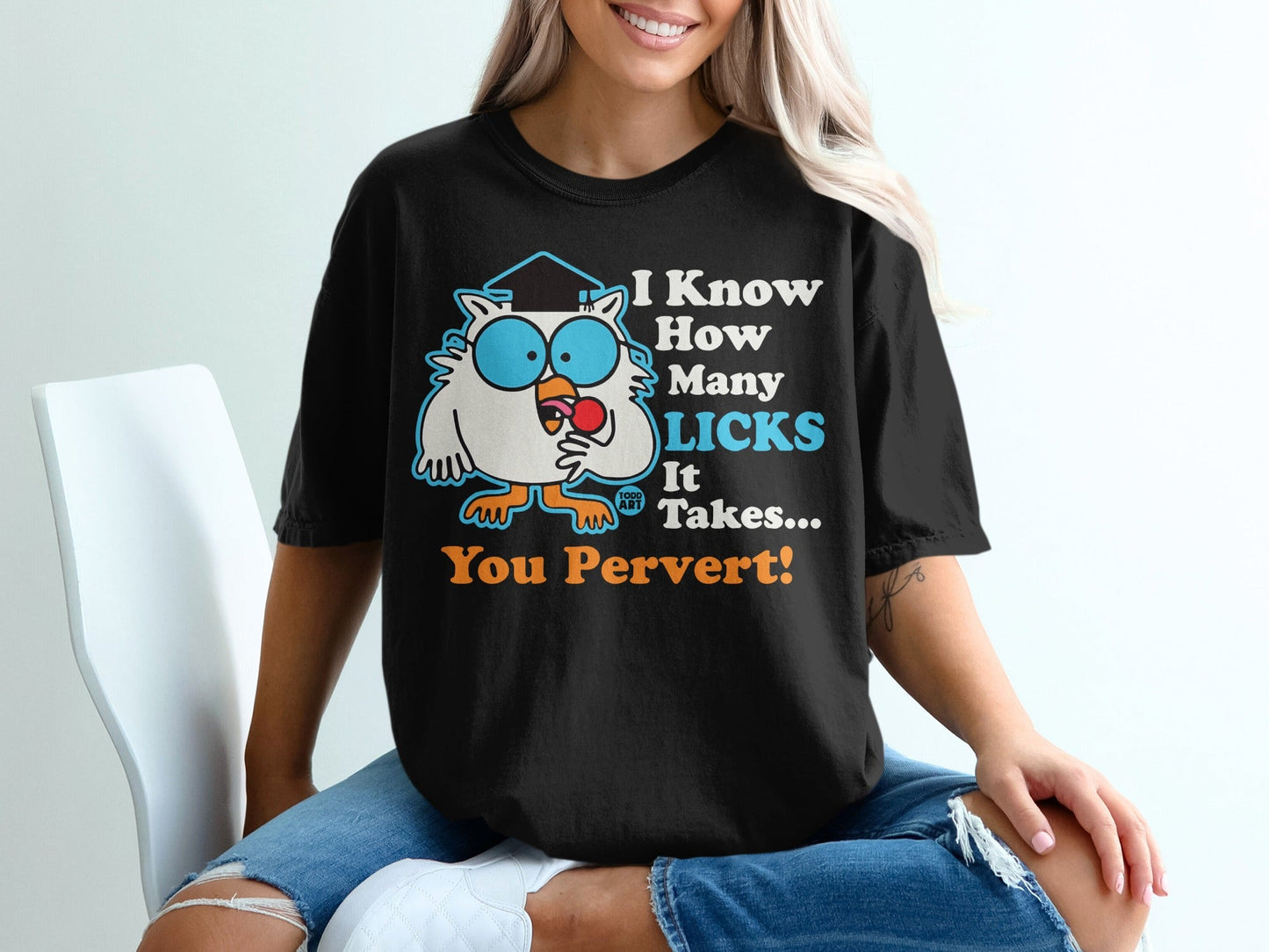 Black t-shirt with cartoon owl, graduation cap, and text "I Know How Many Licks It Takes... You Pervert!".