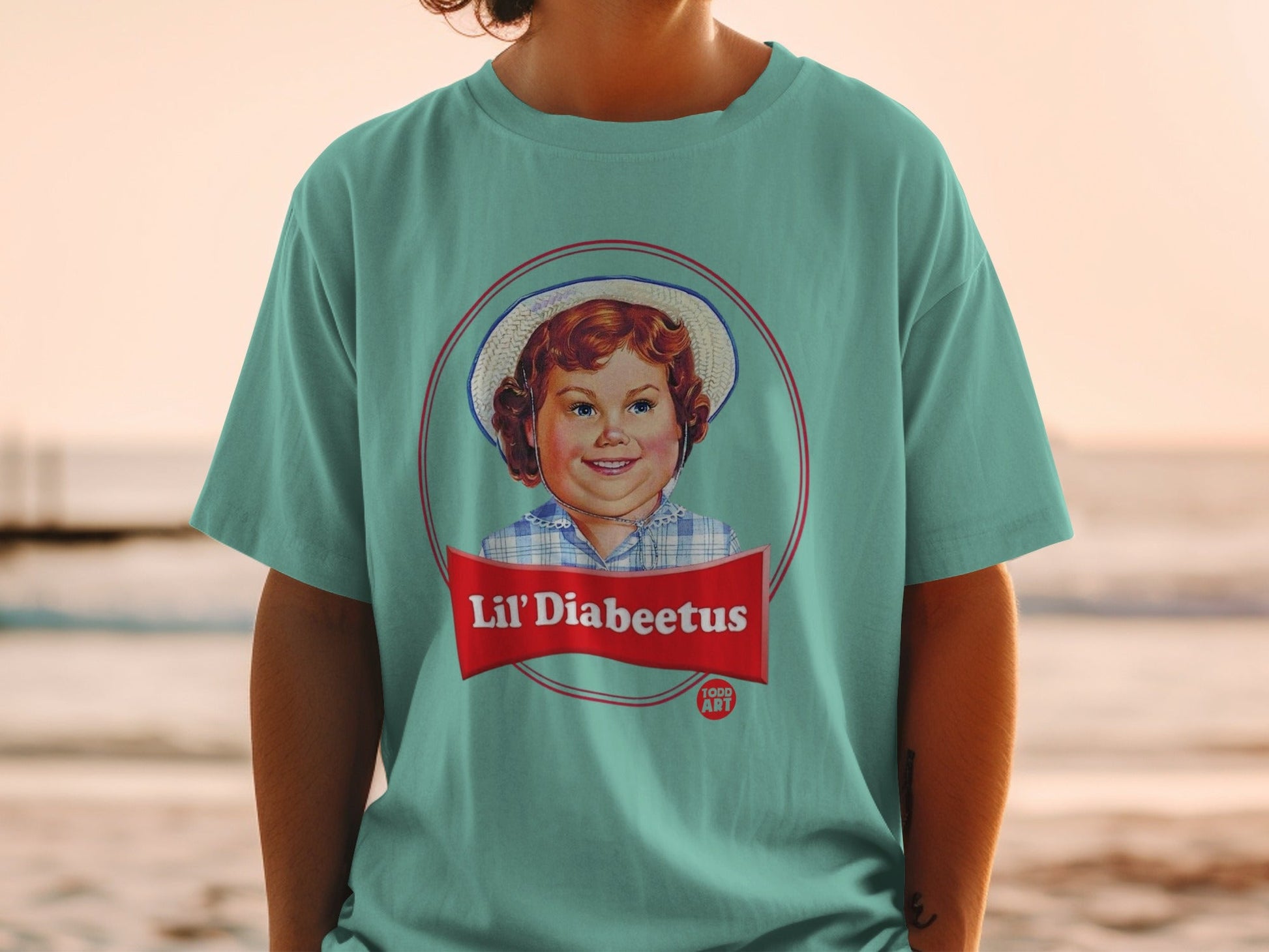 Teal t-shirt featuring a vintage-style illustration of a girl with "Lil' Diabeetus" text.