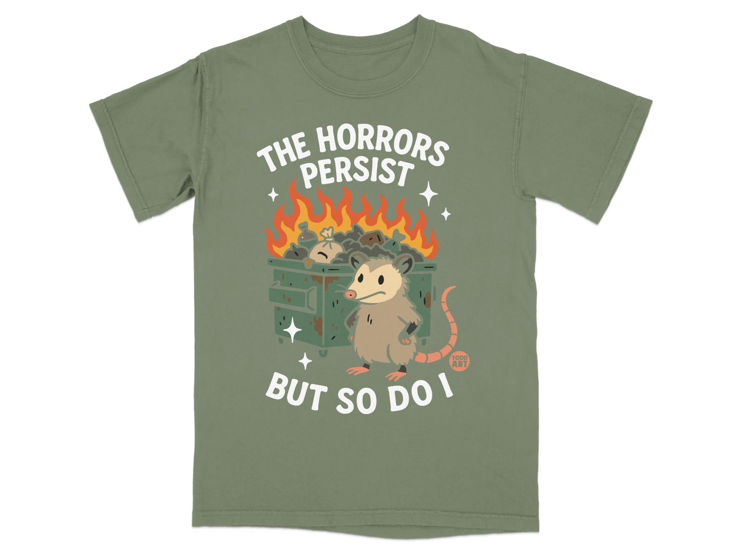 Green t-shirt with cartoon possum and dumpster fire, "The Horrors Persist But So Do I".