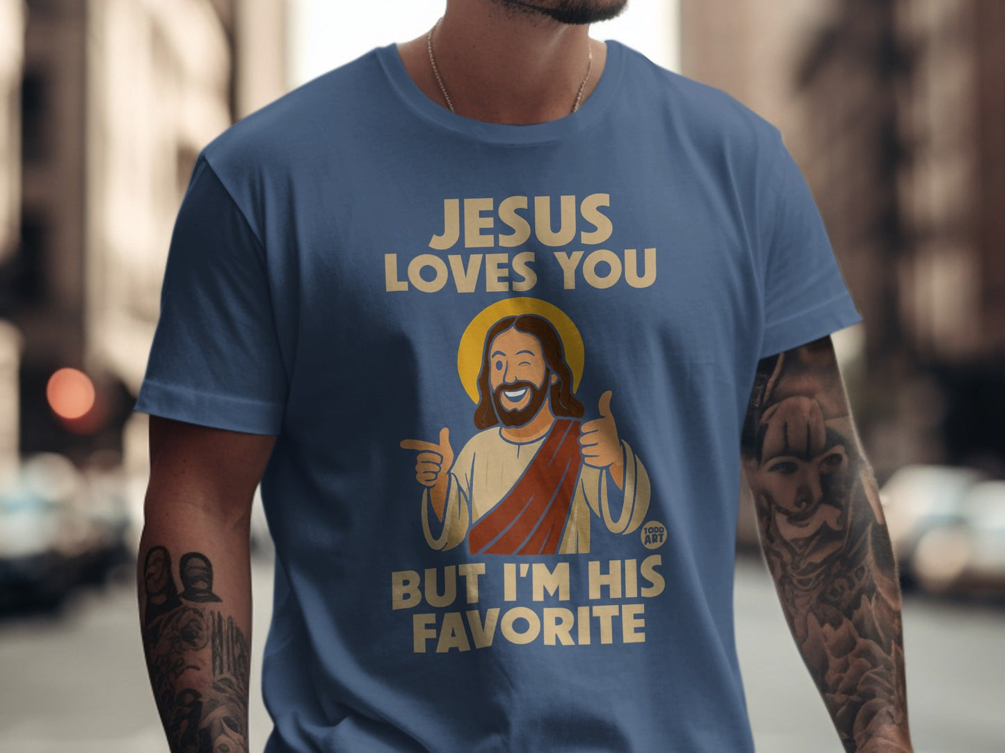 Blue t-shirt with "JESUS LOVES YOU BUT I'M HIS FAVORITE" and Jesus graphic.