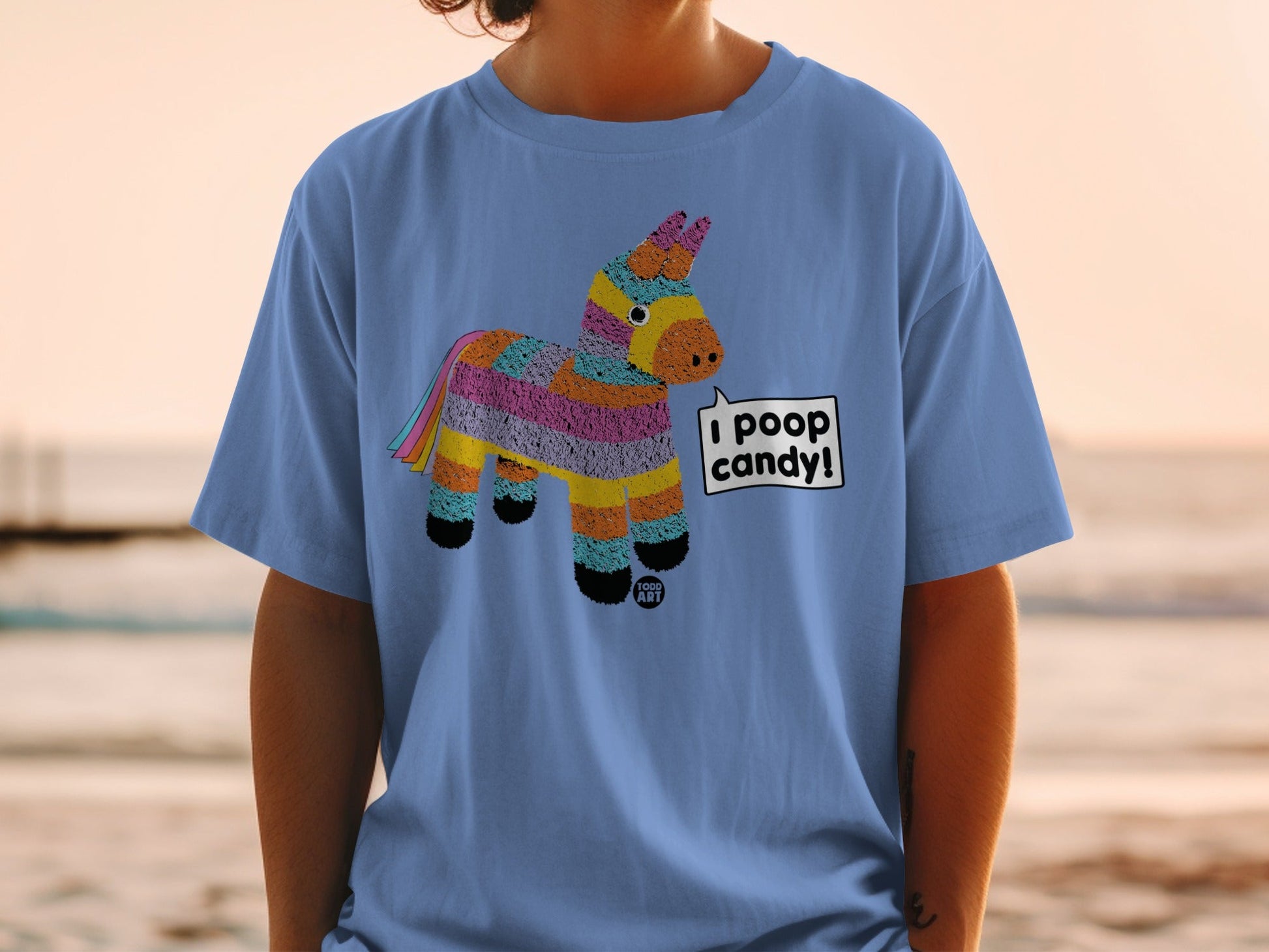 Blue t-shirt with a cartoon donkey pi√±ata that says "I poop candy!".