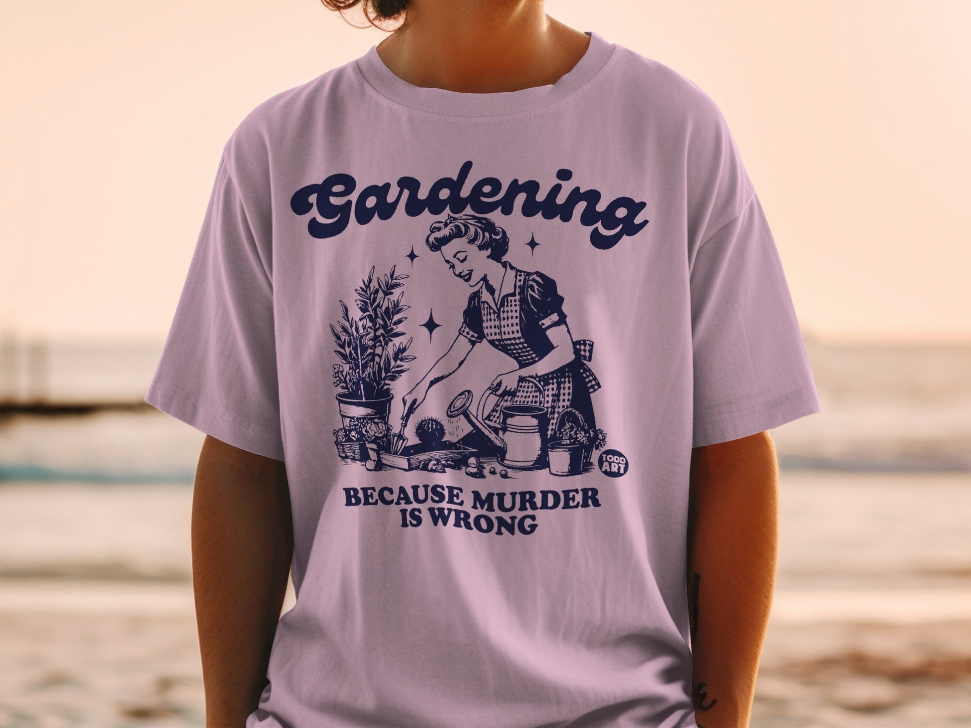 Graphic tee with "Gardening Because Murder Is Wrong" text and vintage gardening illustration.