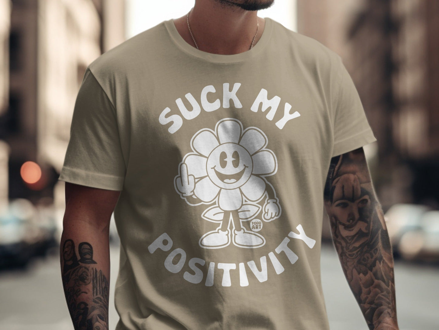 T-shirt with flower graphic saying "Suck My Positivity" with middle finger.