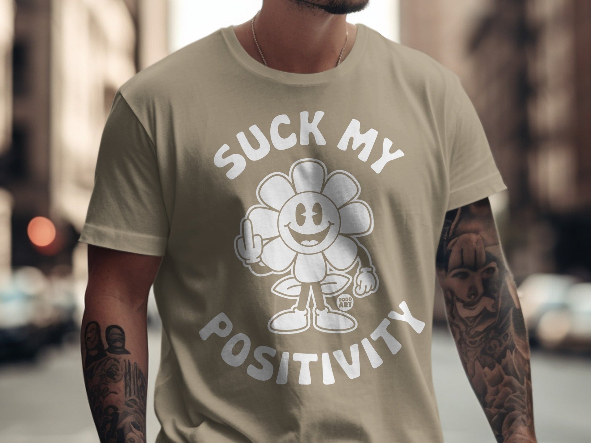 T-shirt with flower graphic saying "Suck My Positivity" with middle finger.