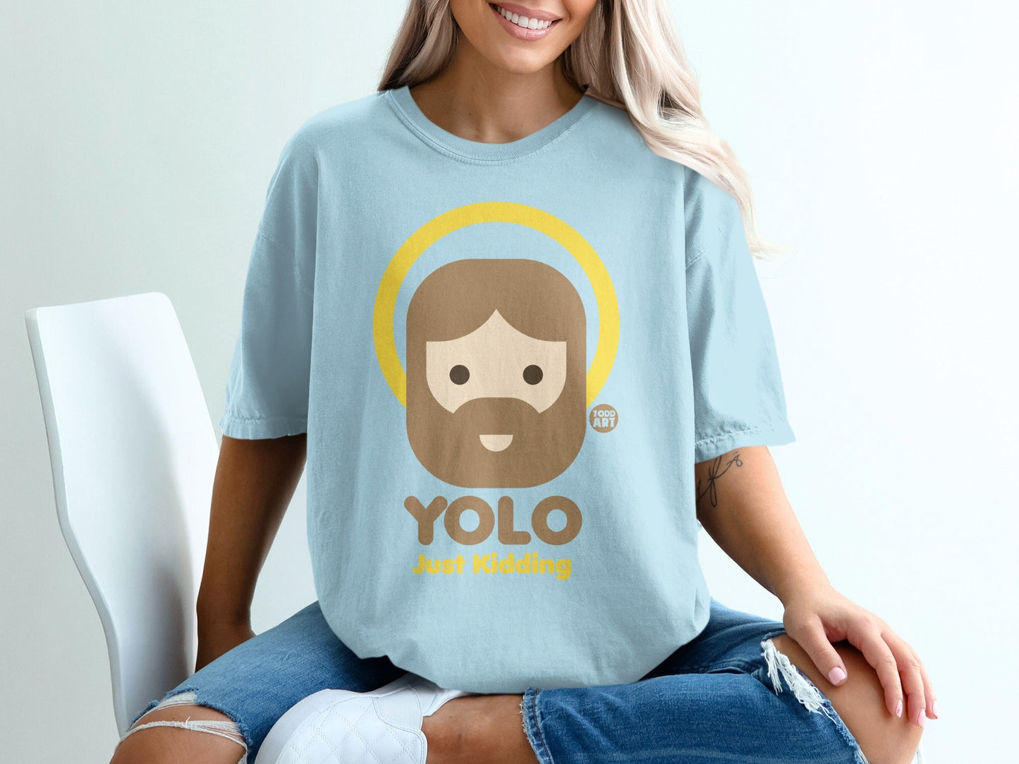 Light blue t-shirt with a cartoon haloed Jesus and text "YOLO Just Kidding".