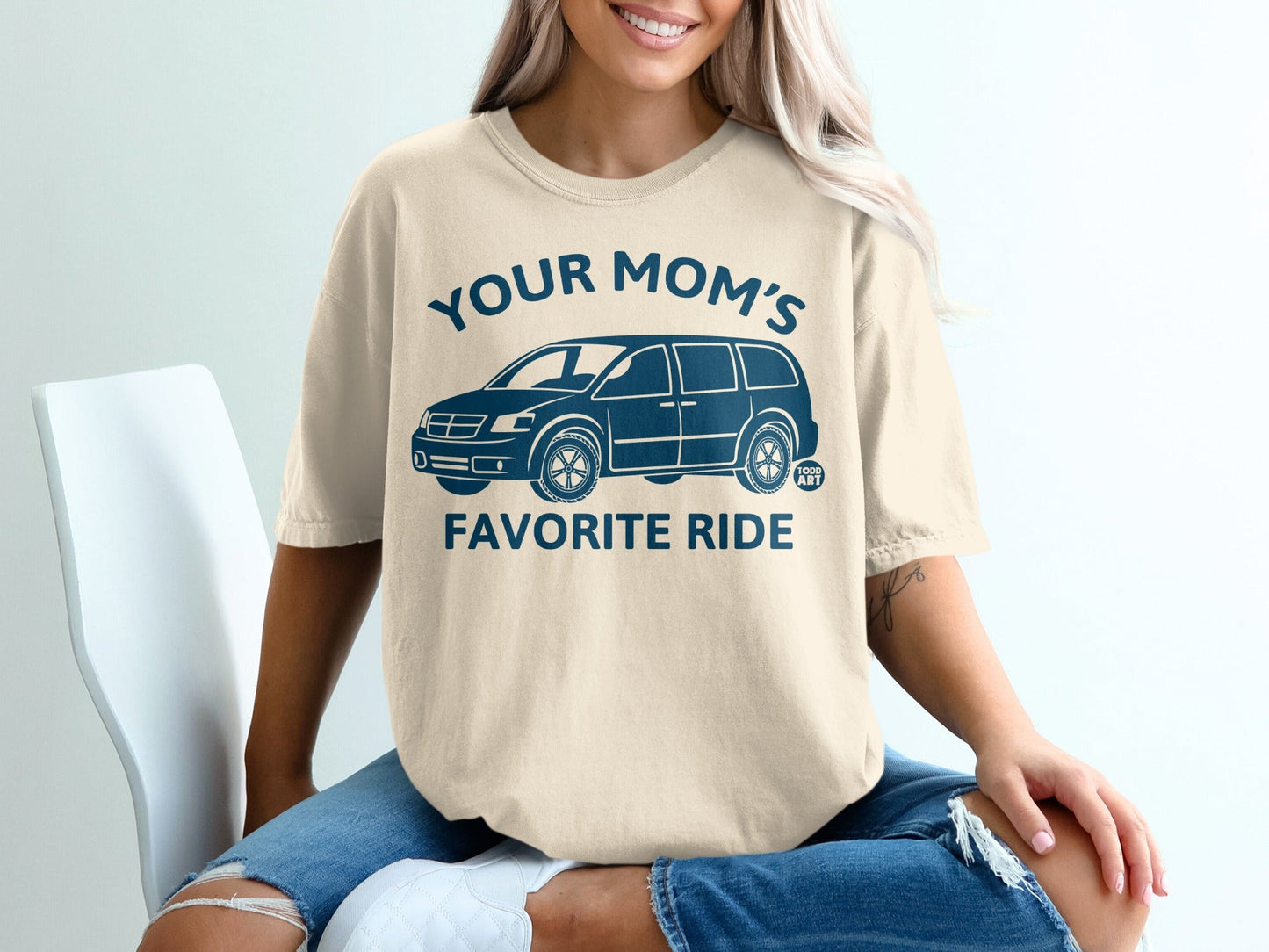 Cream t-shirt with blue graphic of a van and text "YOUR MOM'S FAVORITE RIDE".
