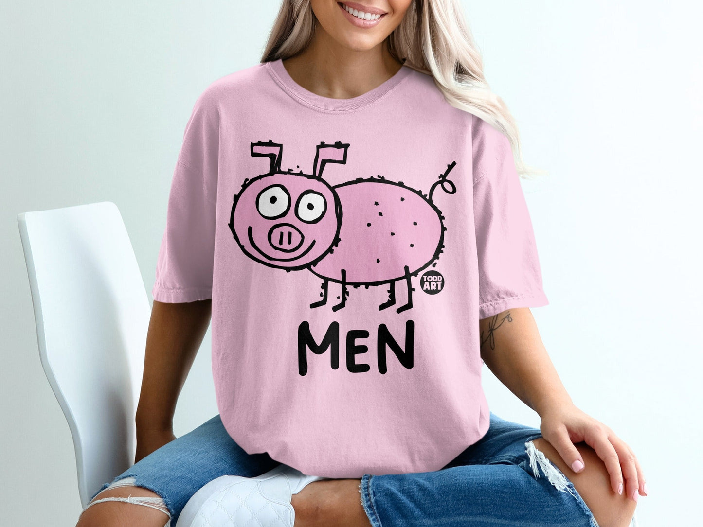 Pink t-shirt with cartoon pig illustration and "MEN" text.