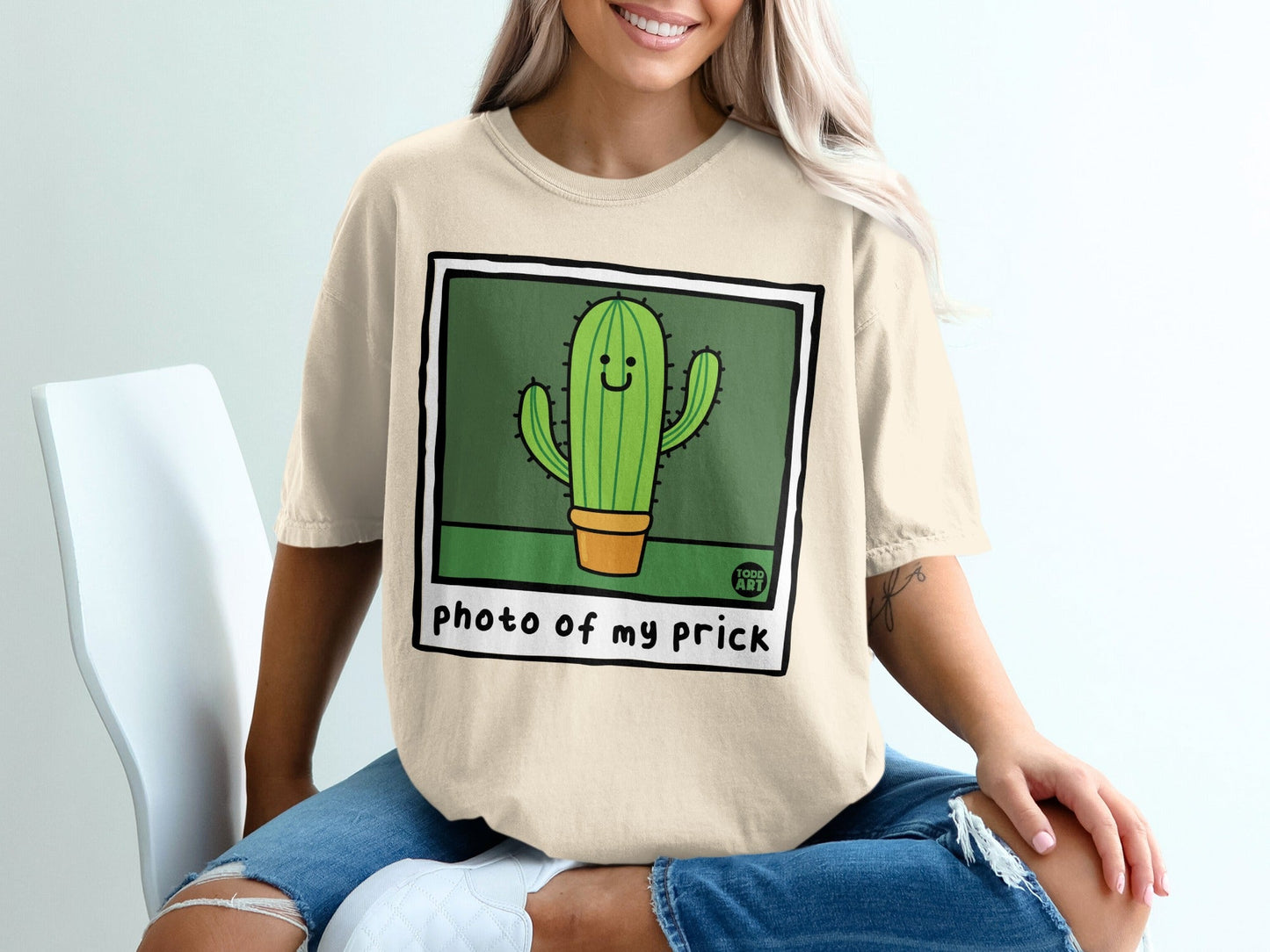 Cream t-shirt with cartoon cactus illustration and text "photo of my prick".