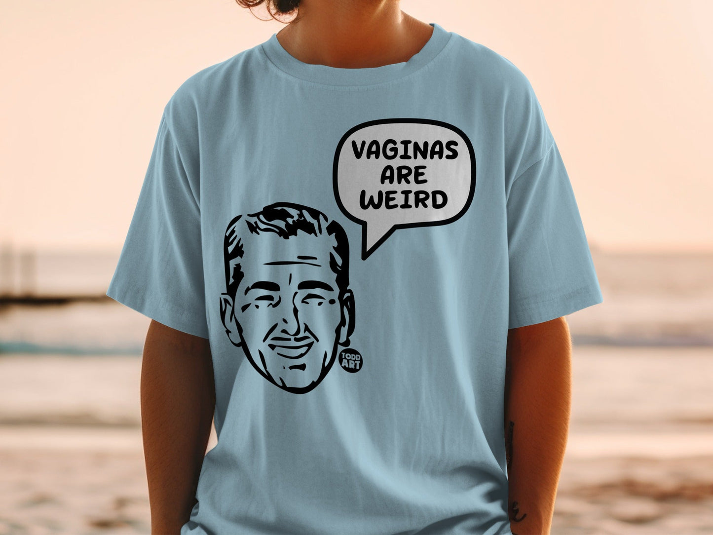 Light blue t-shirt with a black and white illustration of a man's head in a speech bubble.