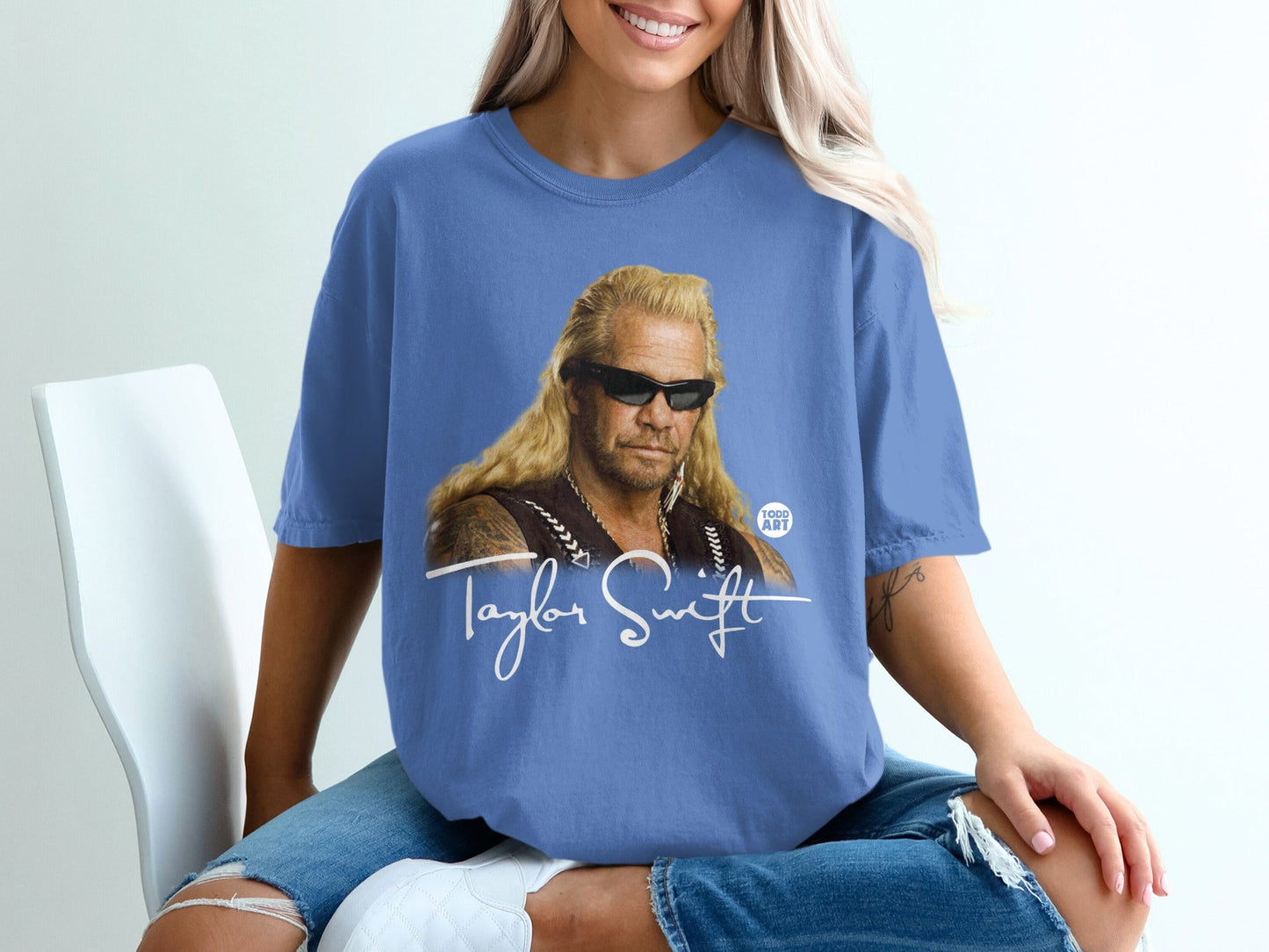 Blue t-shirt with Dog the Bounty Hunter and Taylor Swift graphic.