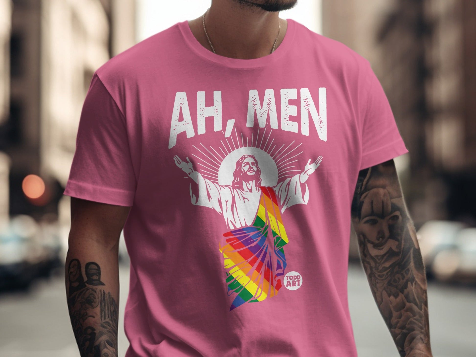 Pink t-shirt with Jesus wearing a rainbow stole, "AH, MEN" text.