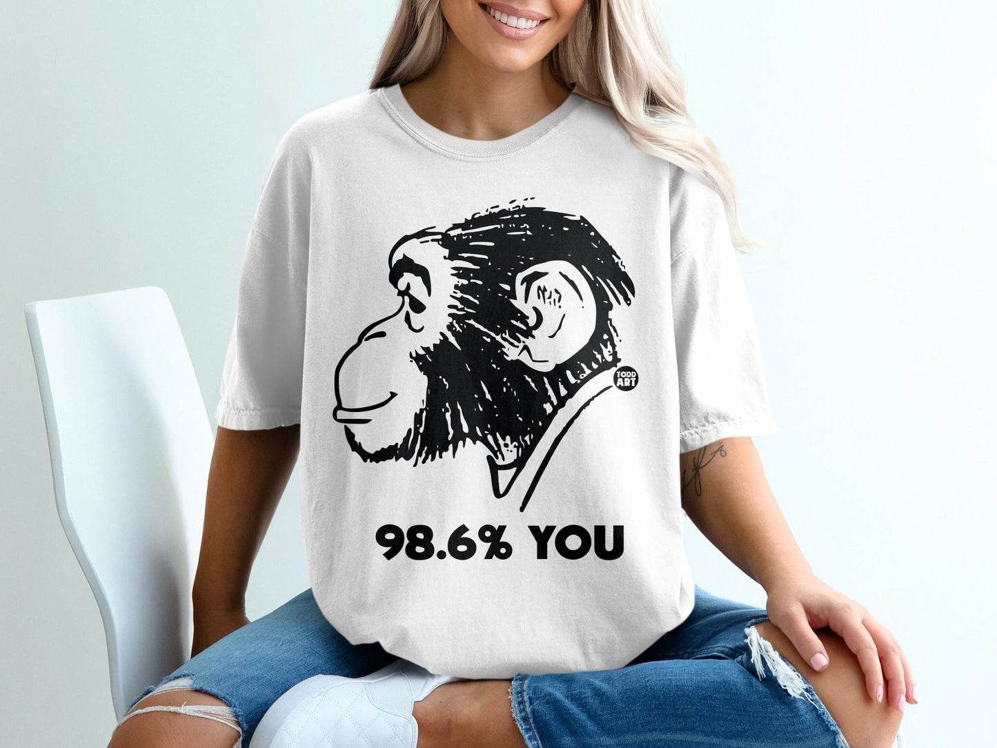 White t-shirt with a black chimpanzee illustration and text "98.6% YOU".