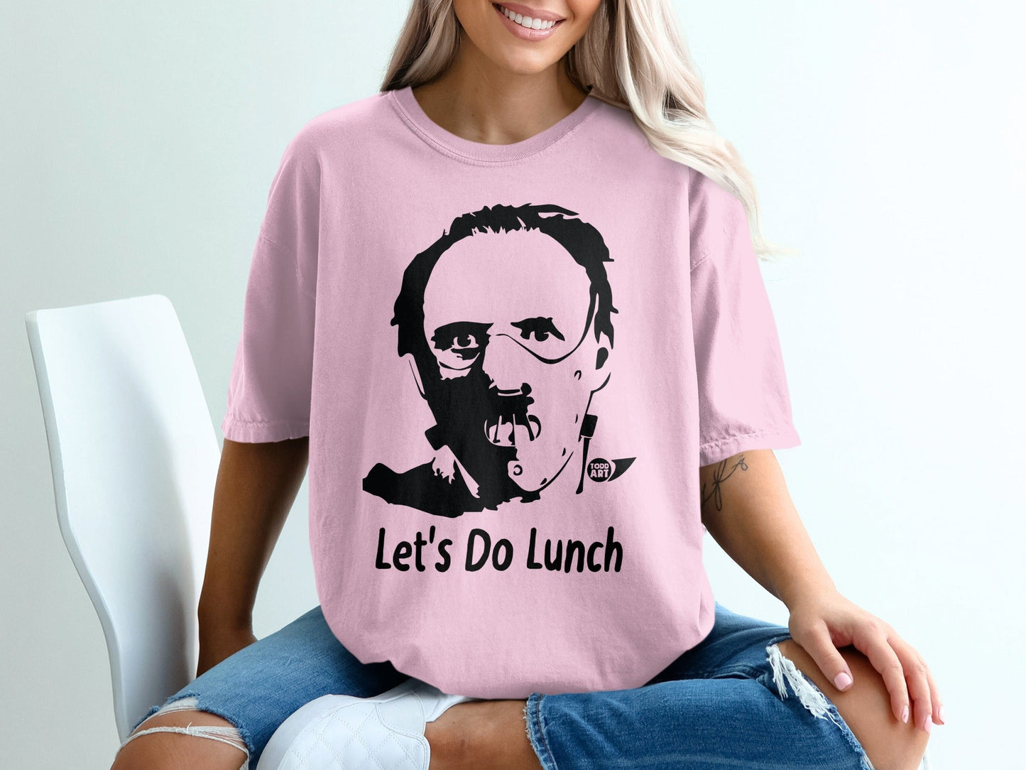 Pink t-shirt with Hannibal Lecter graphic and "Let's Do Lunch" text.